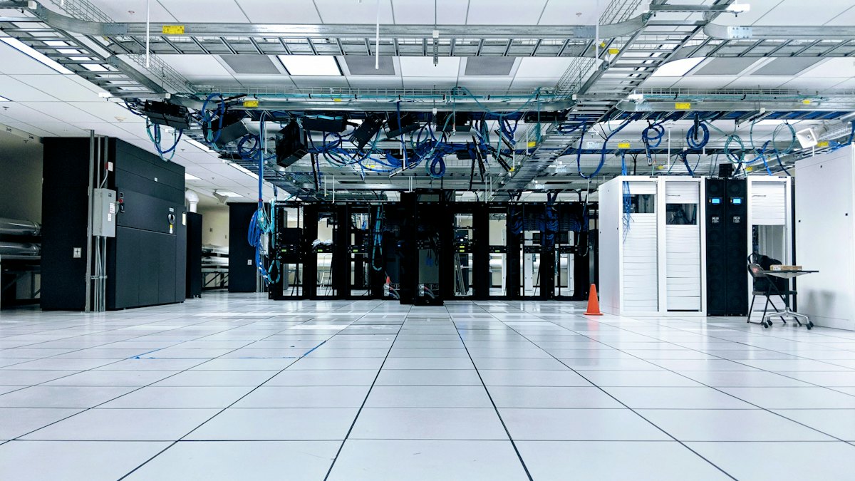 Bright server room with rows of network racks