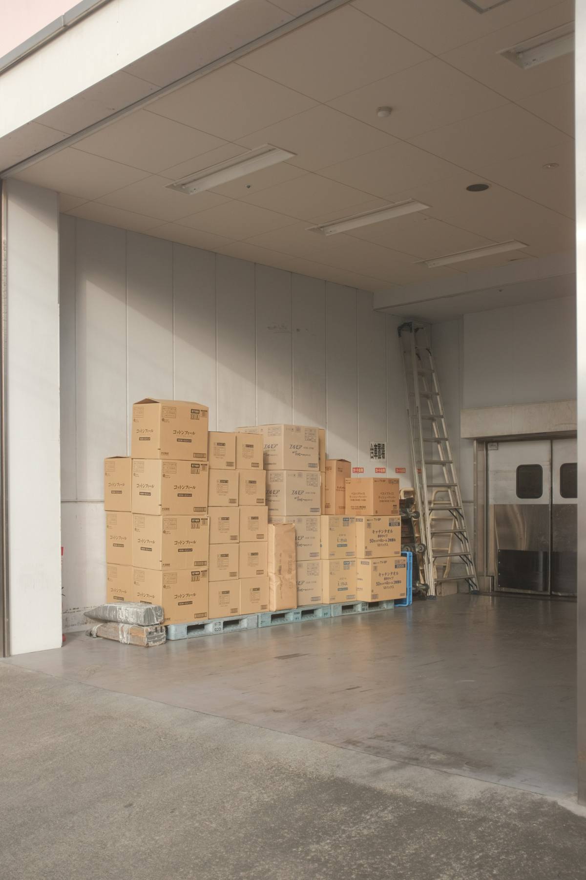 Packed cartons on a pallet in a bright loading area